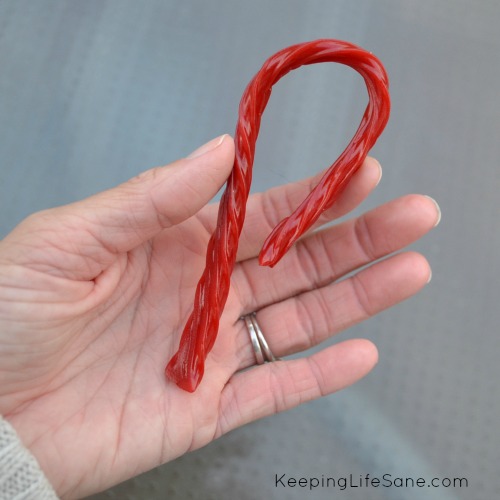 Hand holding red twizzler candy