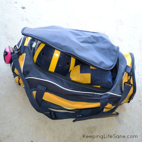 blue and gold duffle bag with football gear inside