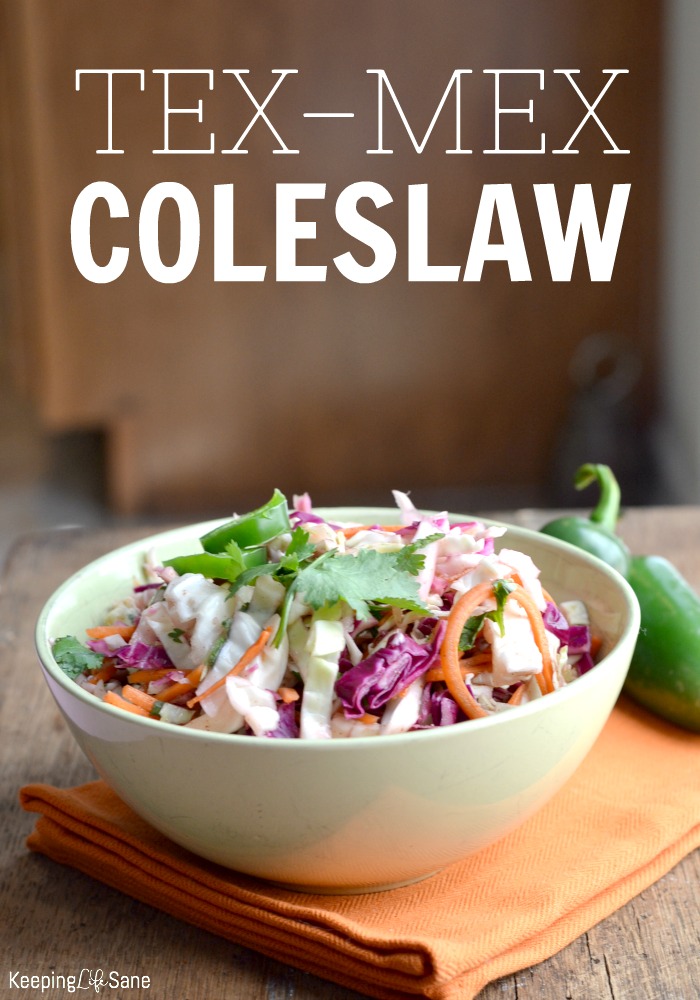 white bowl filled with Mexican coleslaw with orange naplin and jalapenos in the background