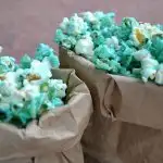 closeup of blue candied pocorn in small paper bags