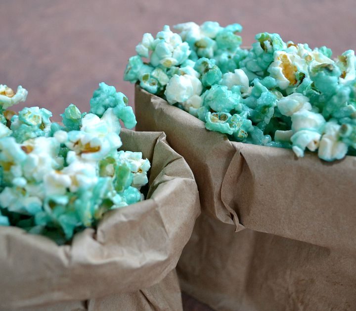 closeup of blue candied pocorn in small paper bags