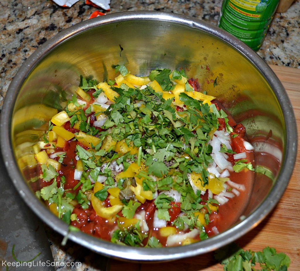 Stainless steel bowl with homemade chunky salsa ingredients