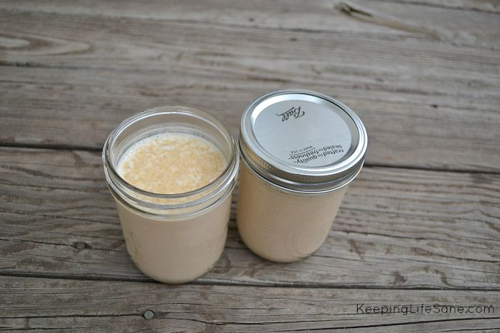 Homemade Pumpkin Spice Coffee Creamer in jars on a wooden table