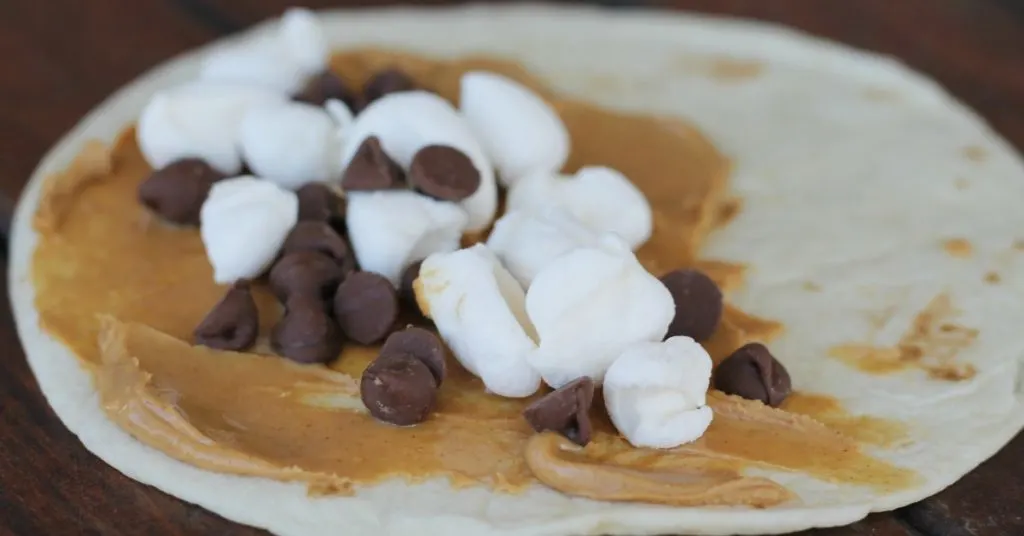 Closeup of torilla with peanut butter mini marshmallows and chocolate chips