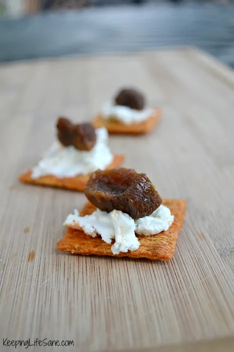 crackers with white cheese on wooden table