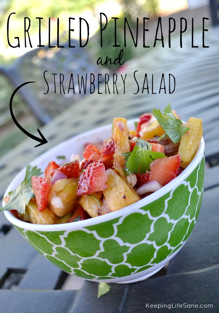 Green bowl with grilled pineapple salad with strawberries with cilantro
