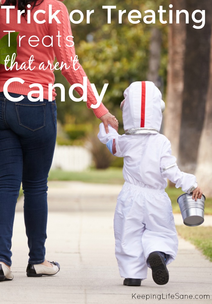 mom walking with kid dressed up as astonaut for Halloween