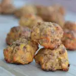 sausage balls with cheese on a cutting board