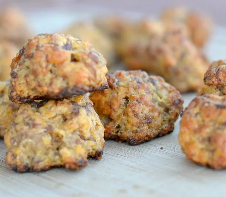 sausage balls with cheese on a cutting board