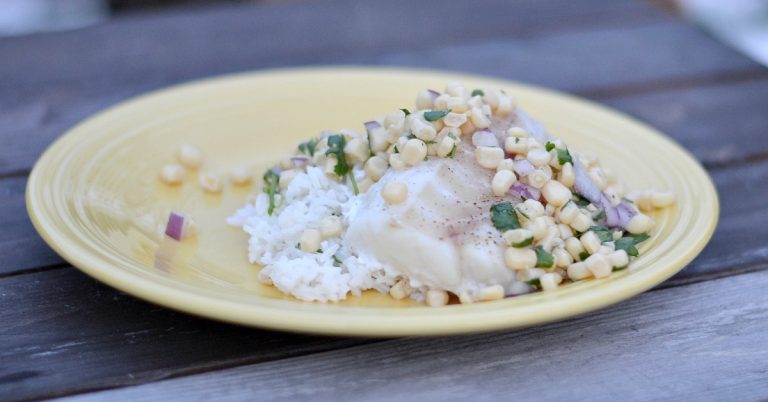 yellow plate with rice cod and corn salsa