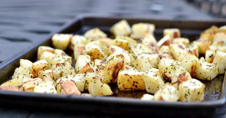 closeup of basil potatoes on baking sheet