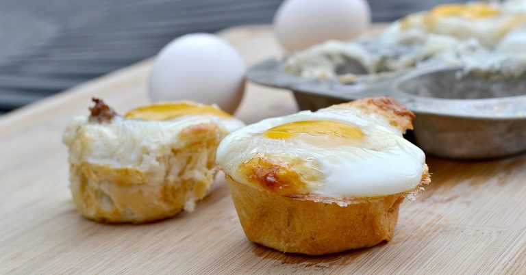 two crescent roll muffins sitting on cutting board