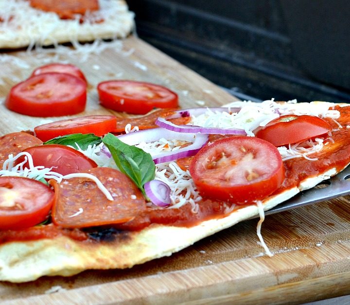 pizza cooking on an outside grill