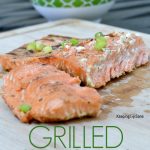 salmon cutting board with green chives on top