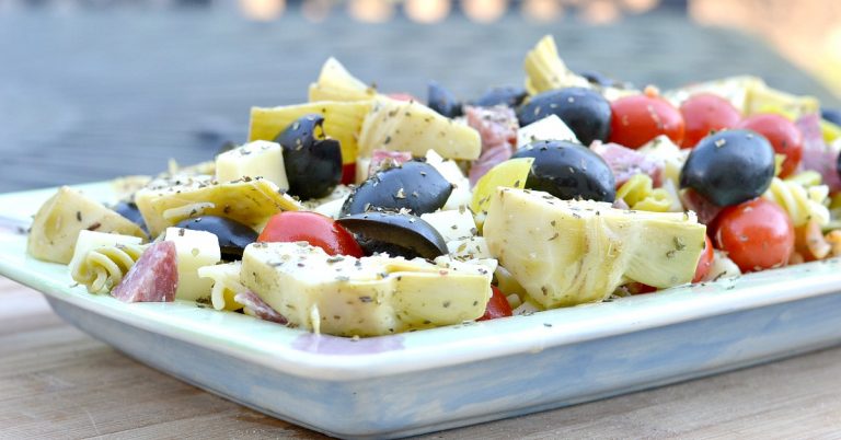 antipasto withrotini, grape tomatoes, olives, cheese cubes, artichokes, salami and cheese cubes