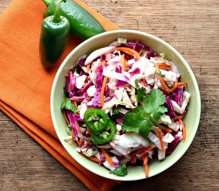 This tex mex coleslaw is perfect for any potluck or cookout. It's easy to throw together and tastes even better the next day.
