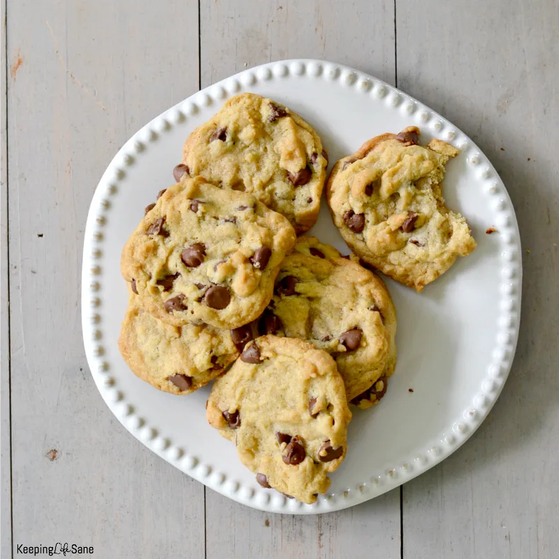 white plate with eggless chocolate chip cookies on it.