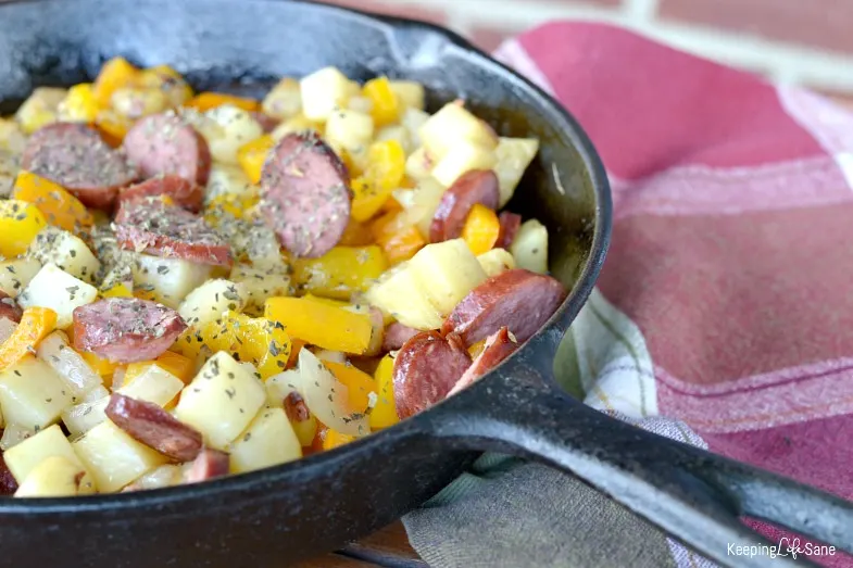 view of potatoes, sausage, pepper and onion in cast iron skillet