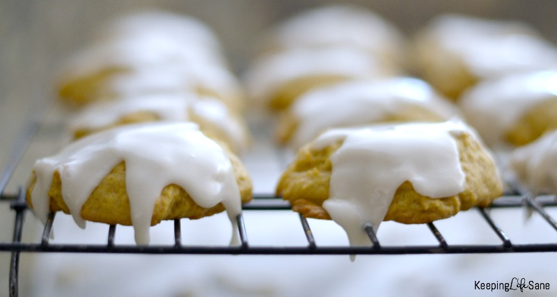 Iced Pumpkin Cookies on wire rack with icing dripping down