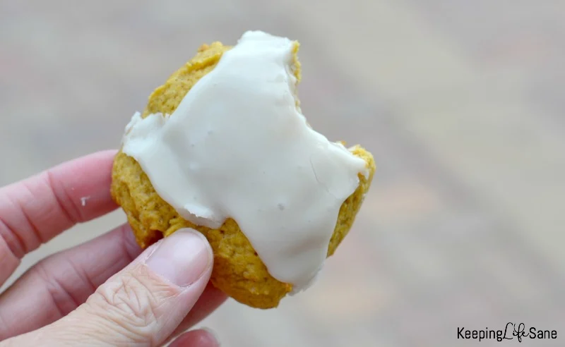 closeup of iced pumpkin cookie with a bite taken out