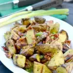 grilled potato wedges, overhead view with green onion sprinkled on