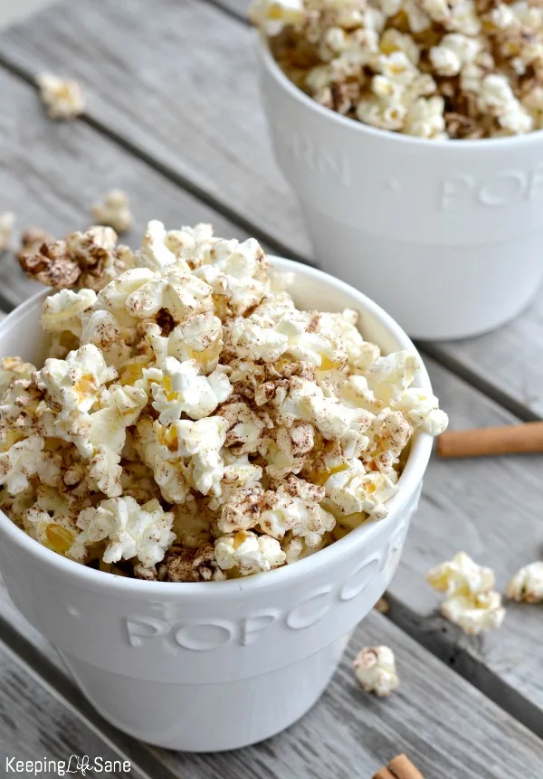 white popcorn bowl with cinnamon popcorn recipe overflowing