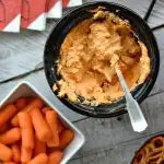 OVerhead view of mini slow cooker with buffalo chicken dip and carrots on the side