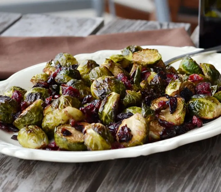 White bowl with Brussels sprouts and craisins