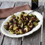 White bowl with Brussels sprouts and craisins with spoon