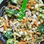 closeup overhead view of skillet with pasta, broccoli and chicken meal
