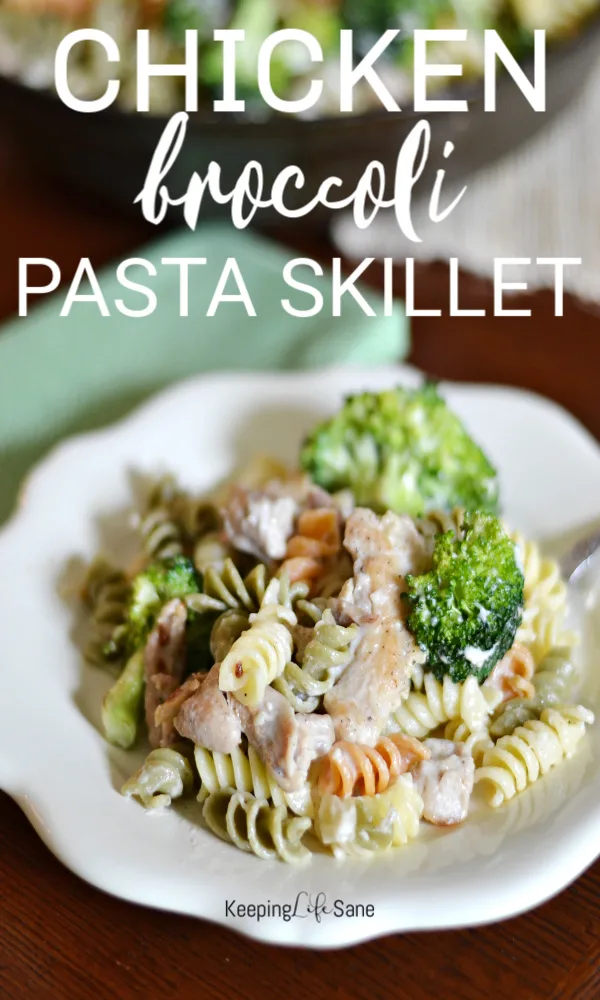 small white plate with tricolored rotini pasta, broccoli and chicken