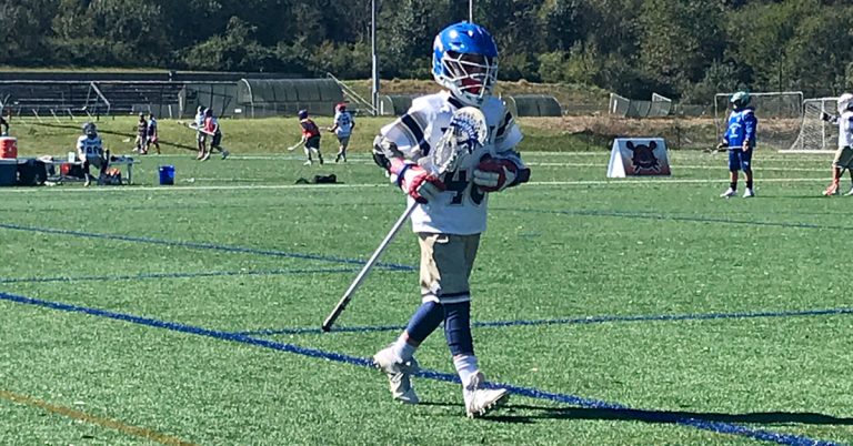lacrosse player running out onto the field