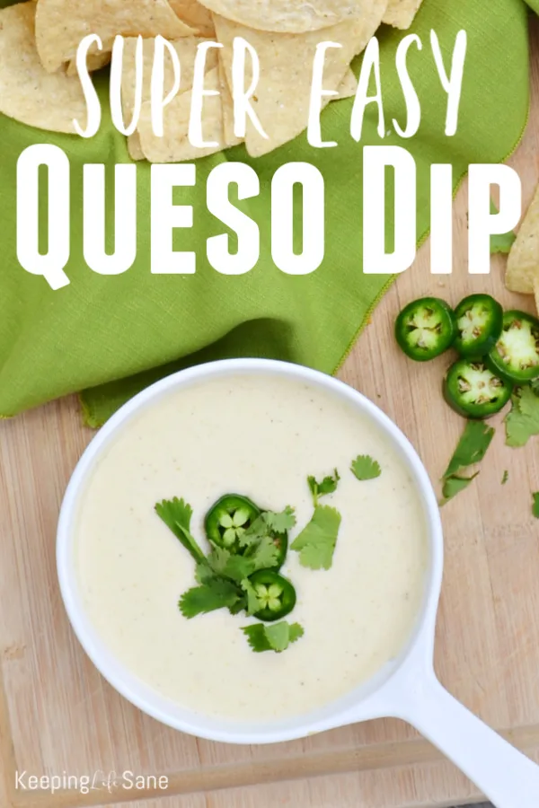 white bowl with queso dip with green napkin, chips and jalapeno slices