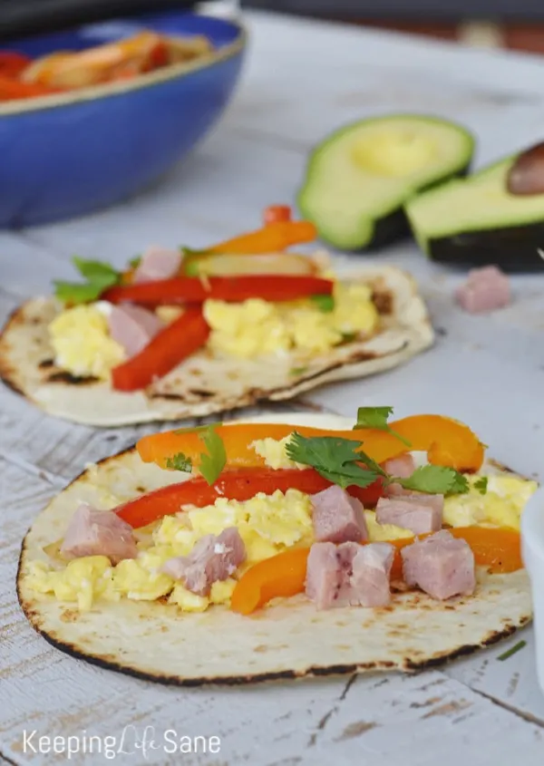Are you looking for a new breakfast idea? These easy breakfast fajitas are delicious and everyone loves them. They're perfect for a crowd. #Breakfast #BreakfastRecipe #BreakfastFajitas #BreakfastIdea #EasyBreakfast #HealthyBreakfast #Recipe #Fajitas #Ham #Peppers #Cilantro