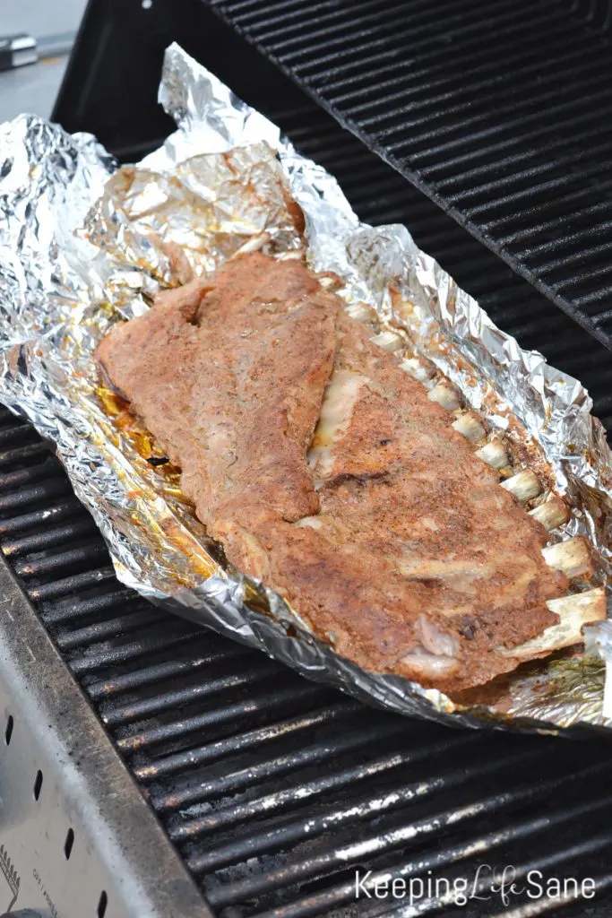 rib laying on foil on grill