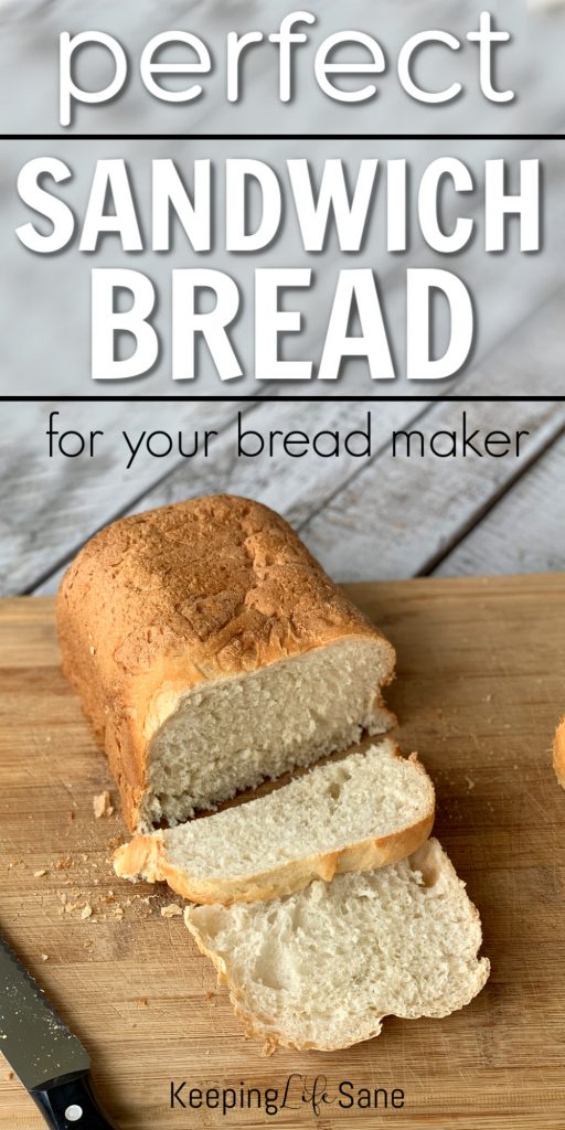 bread on a cutting with bread knife with a few slices cut.