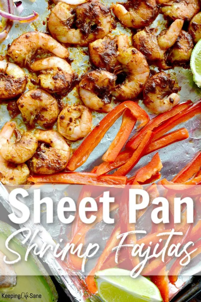 view of cooked shrimp, red peppers and lime on foil line baking sheet