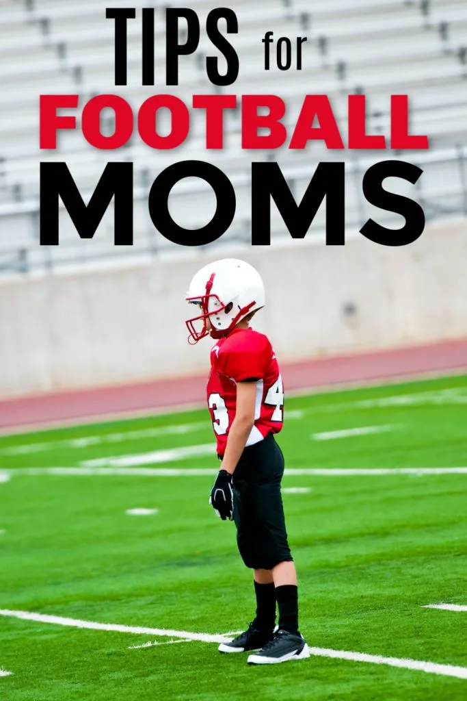 football player in red jersey standing on green football field