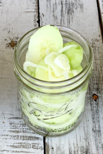 three jars of cucumbers and onions