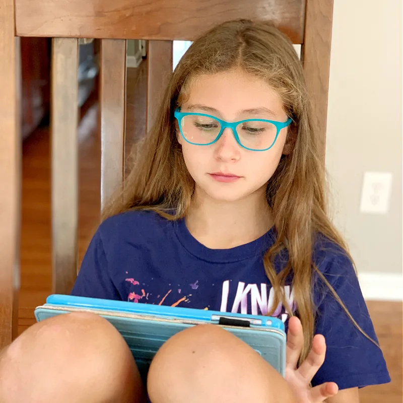 girl in glasses on iPad