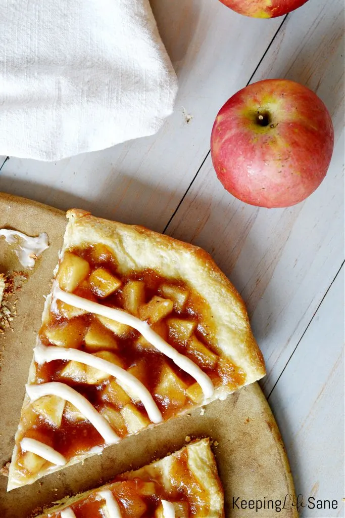 overhead view of slice of apple pizza recipe with red apple