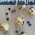 5 blueberry muffins from overhead with blueberries sprinkled around.
