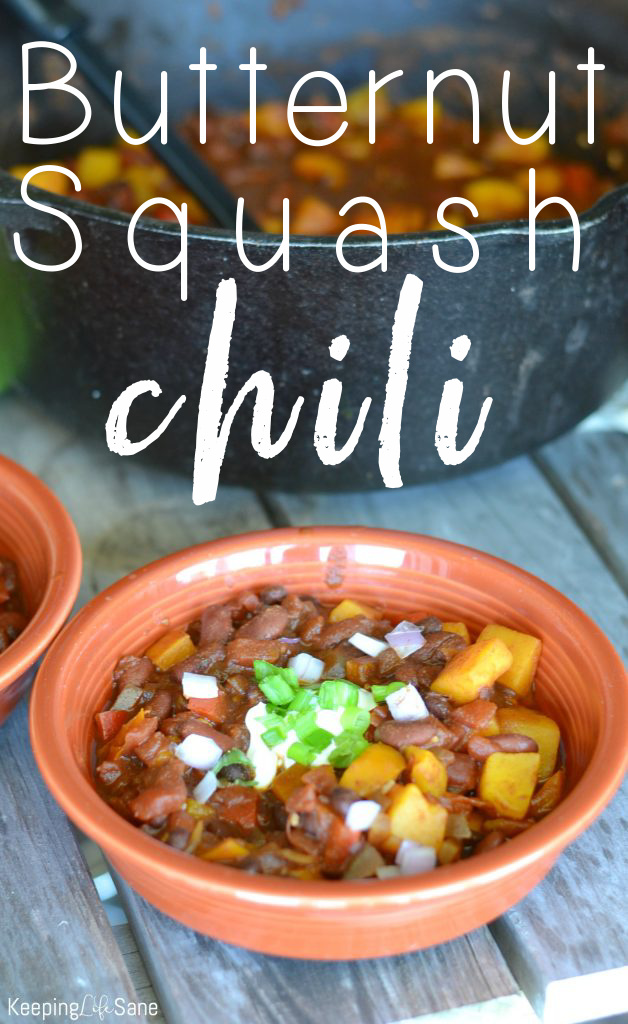 Bowl of butternut squash chili with sour cream and green onions