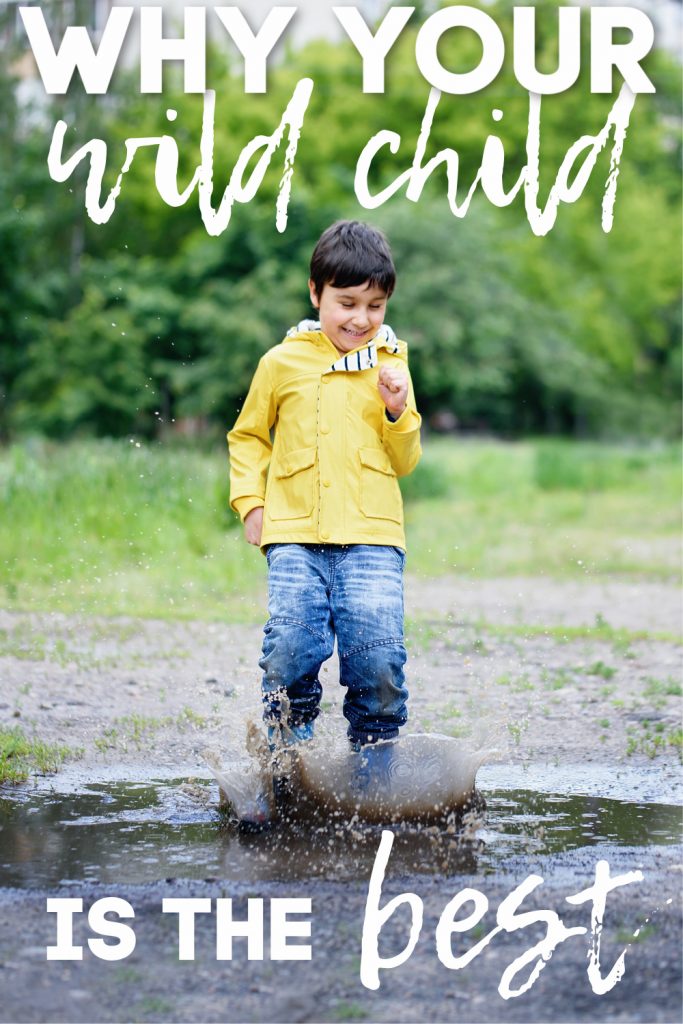 boy in yellow rain jacket jumping in muddy puddle