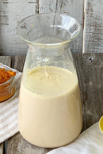small bowl of pumpkin puree, bottle of creamer with yellow lid to the side