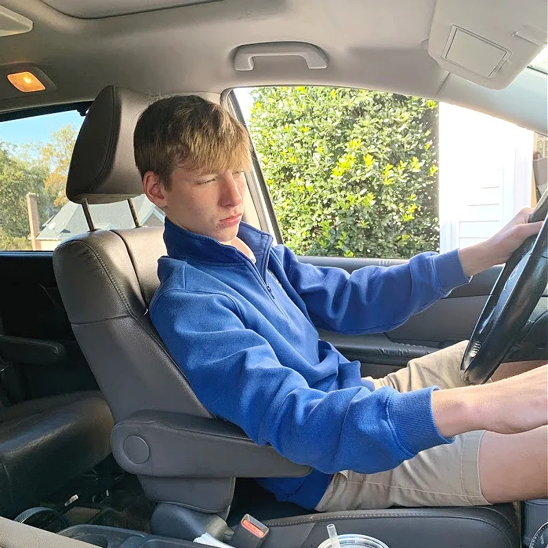 teen boy in drivers seat of van