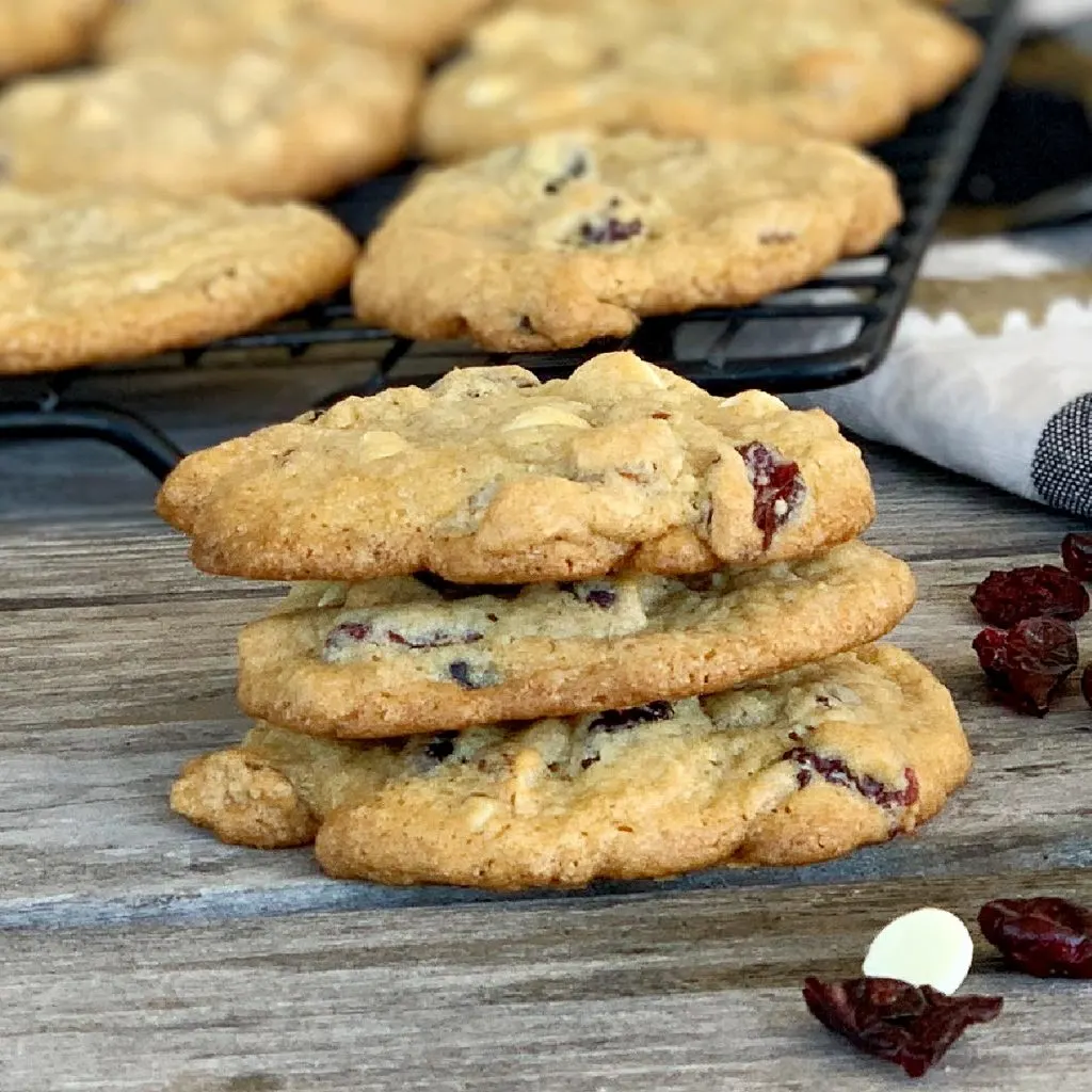 stack of three eggless white chocolate chip cookies