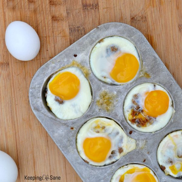 overhead view of muffin tin with baked eggs on top