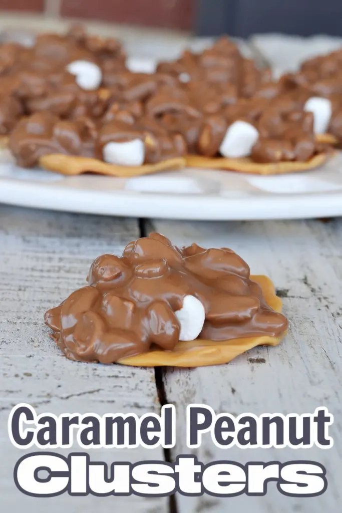 closeup of gooey caramel and chocolate cluster with white tray with more clusters in background