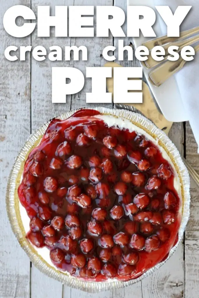 overhead view of cherry cream cheese pie with cherries on top on wooden table